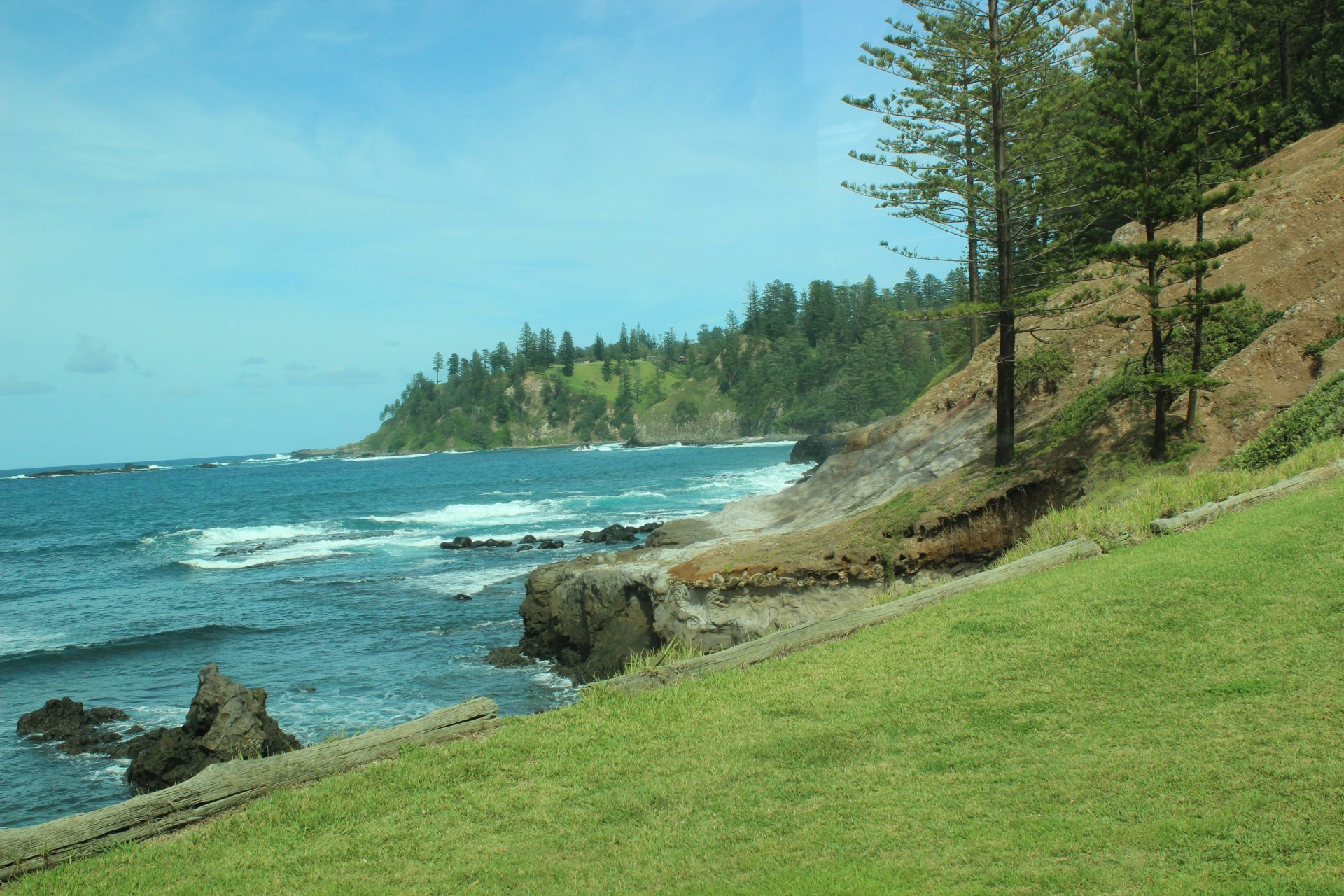 A view of the ocean from a grassy hill